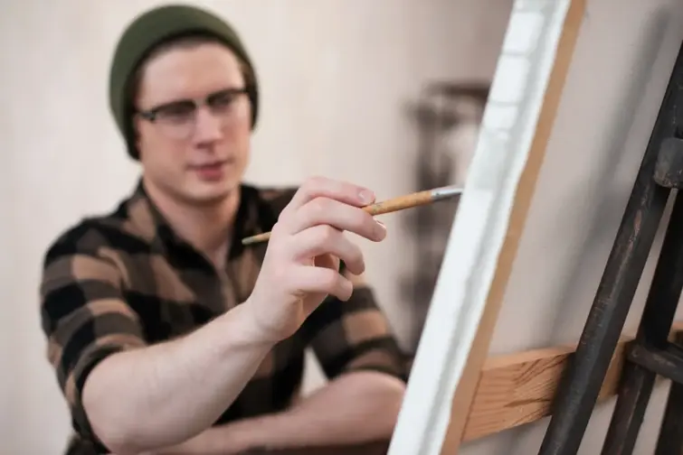 Jovem a pintar uma tela